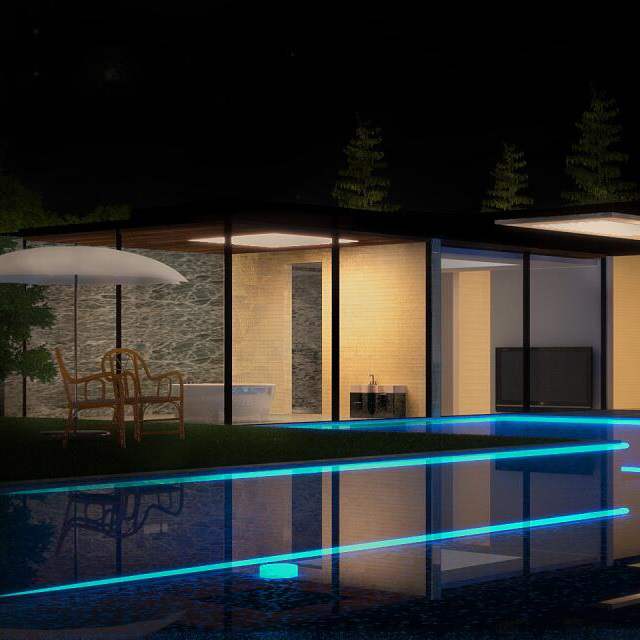 Outdoor pool bordered with continuous blue linear lighting at night
